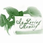 Greenery wrapped around a scroll with cursive writing "In Loving Memory"
